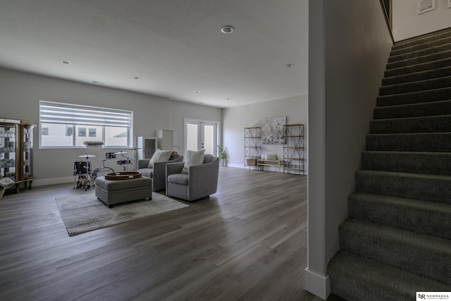 living room with dark wood-type flooring and french doors