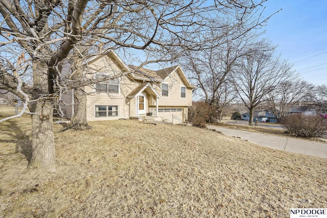 view of front of property with a garage and a front lawn