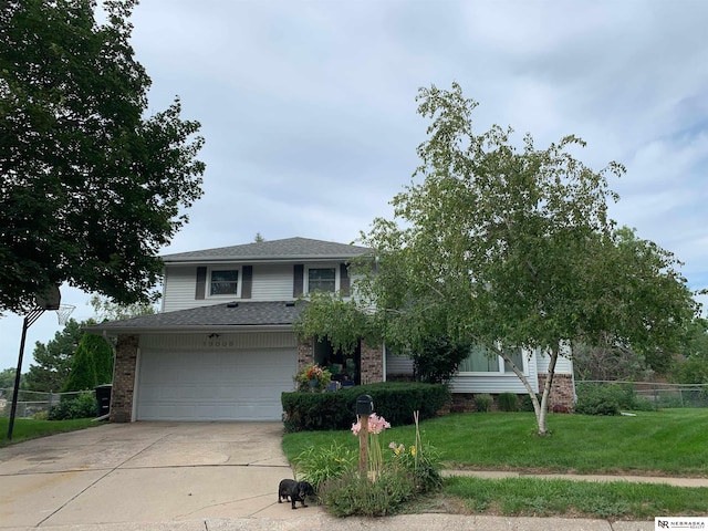 view of front of house with a garage and a front yard