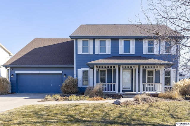 view of front of house featuring a porch, a garage, and a front yard