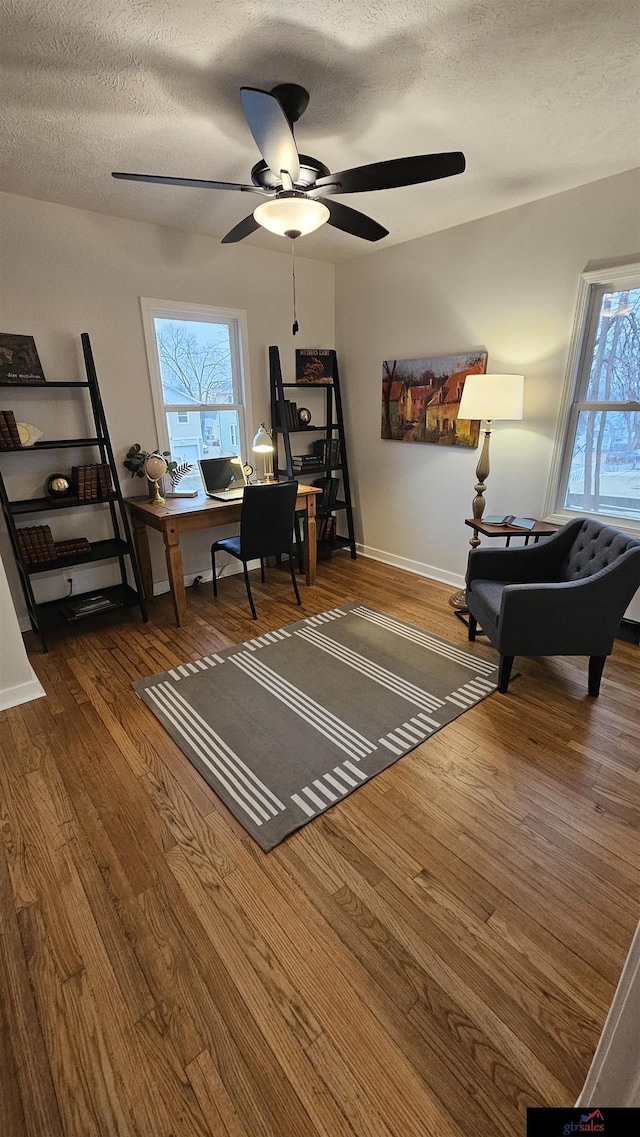 office with ceiling fan, wood-type flooring, and a textured ceiling