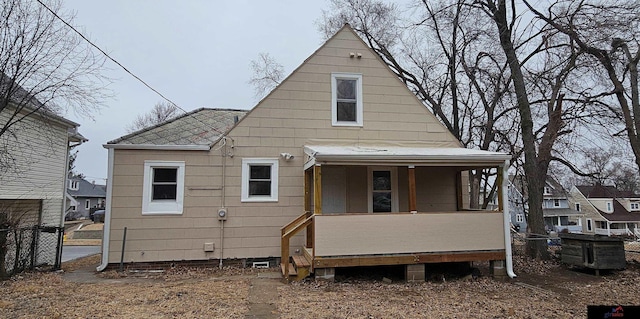 back of property with covered porch