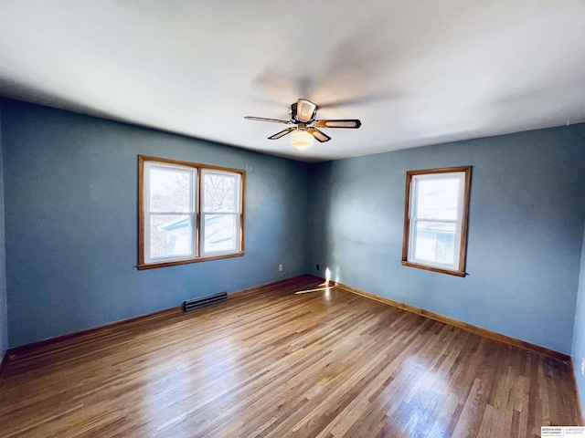 empty room with wood-type flooring and ceiling fan