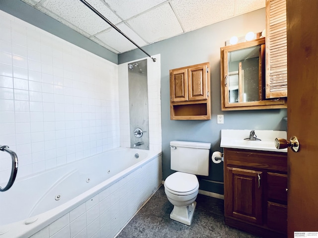 full bathroom featuring vanity, tiled shower / bath, a paneled ceiling, and toilet