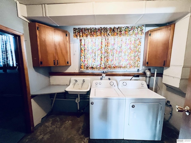 laundry area with cabinets, sink, and washer and clothes dryer