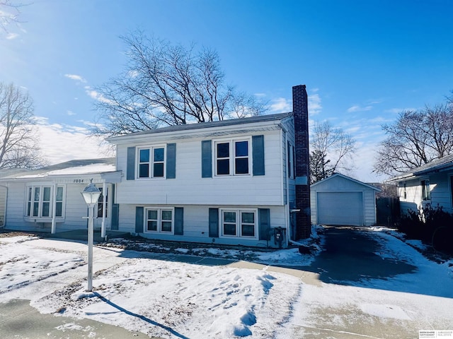 split level home with a garage and an outbuilding