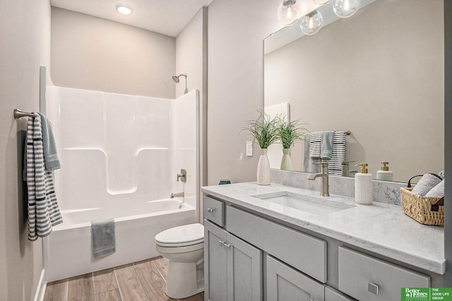 full bathroom with vanity, wood-type flooring,  shower combination, and toilet