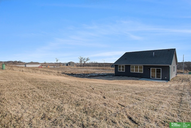 rear view of house with a yard and a patio