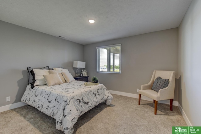 carpeted bedroom featuring a textured ceiling