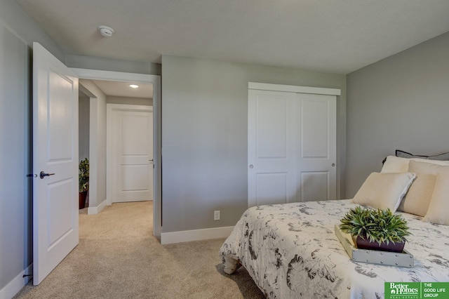 bedroom with light carpet and a closet