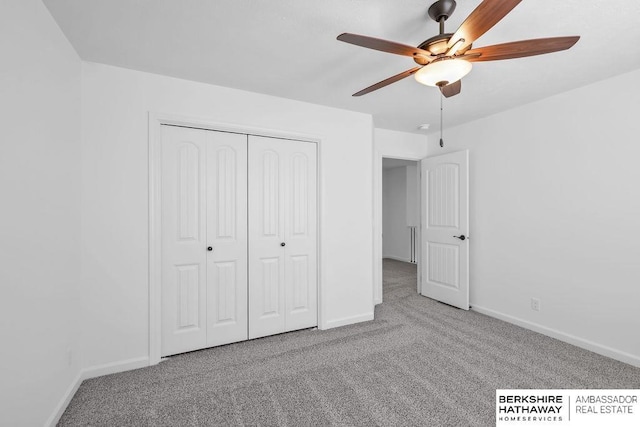 unfurnished bedroom featuring ceiling fan, a closet, and light carpet