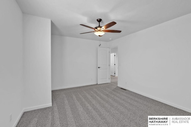 spare room featuring carpet floors and ceiling fan