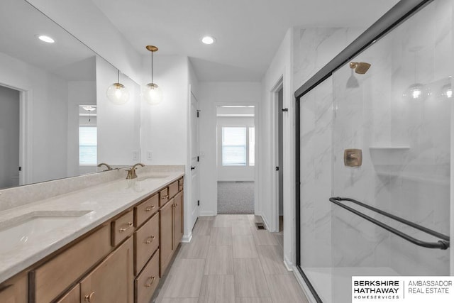 bathroom with vanity and a shower with door