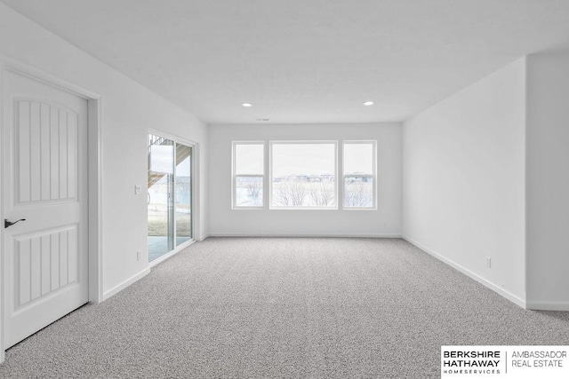 carpeted spare room featuring a wealth of natural light