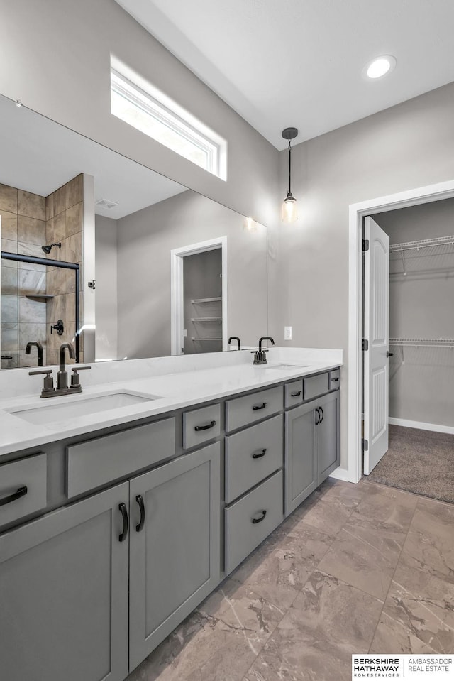 bathroom with vanity and a shower with shower door