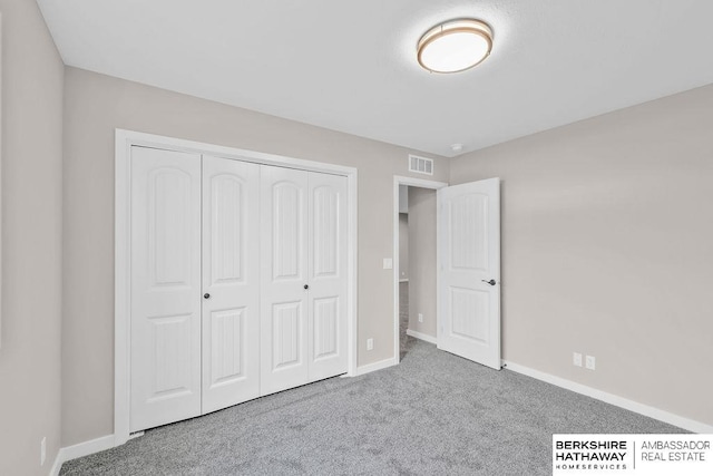 unfurnished bedroom featuring carpet and a closet