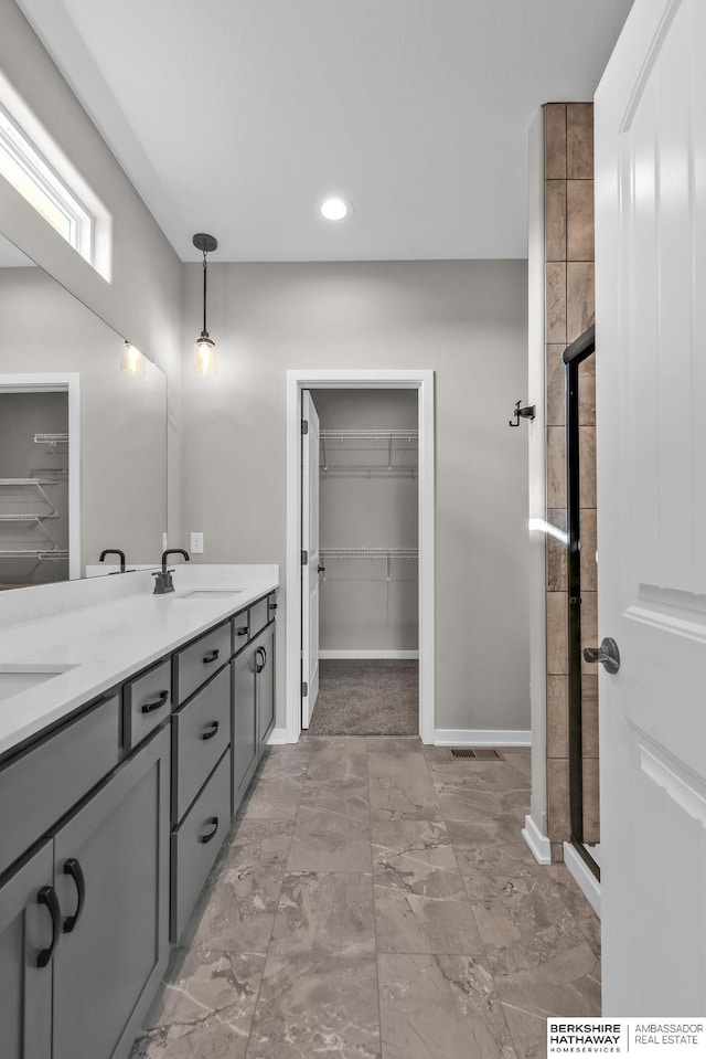 bathroom with walk in shower and vanity