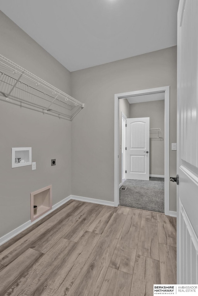 laundry area with hookup for a washing machine, hookup for an electric dryer, and light wood-type flooring