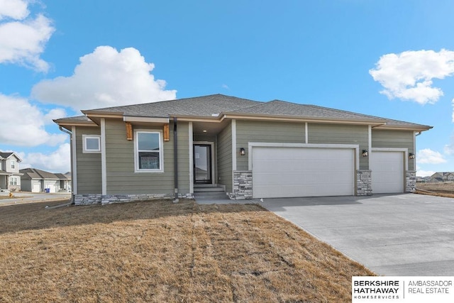 view of front of property featuring a garage and a front lawn