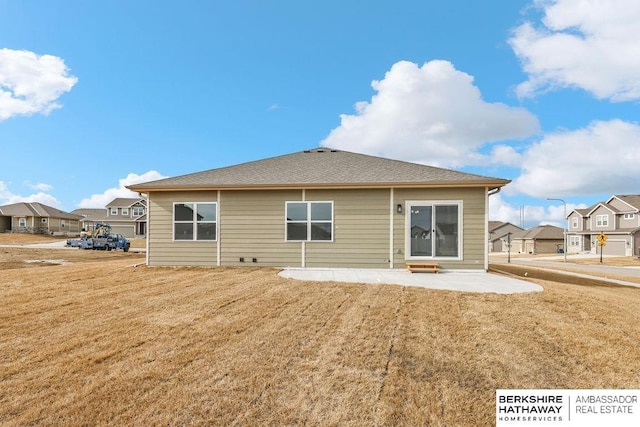 rear view of property featuring a patio area and a lawn