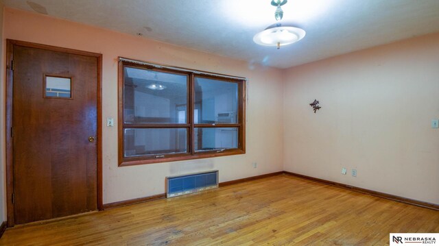 unfurnished room with light hardwood / wood-style floors