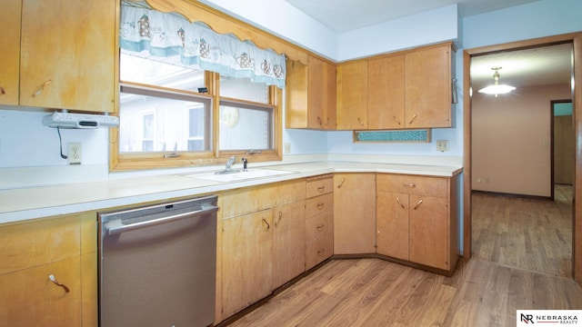 kitchen featuring stainless steel dishwasher, decorative light fixtures, sink, and light wood-type flooring