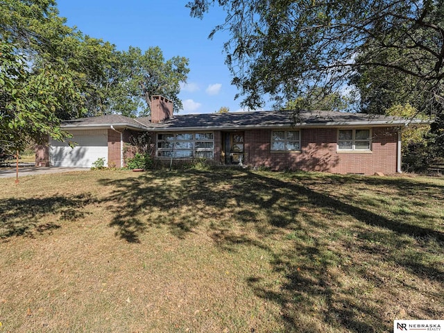 ranch-style home with a garage and a front yard