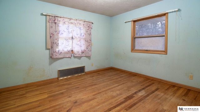 spare room with light hardwood / wood-style flooring