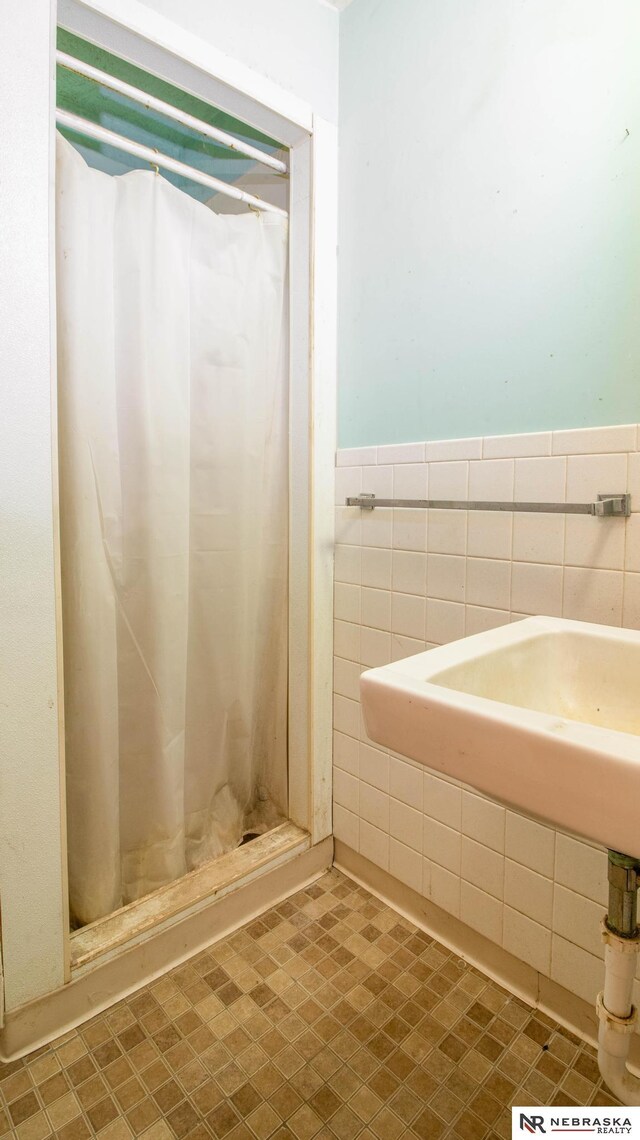 bathroom with tile walls and a shower with curtain