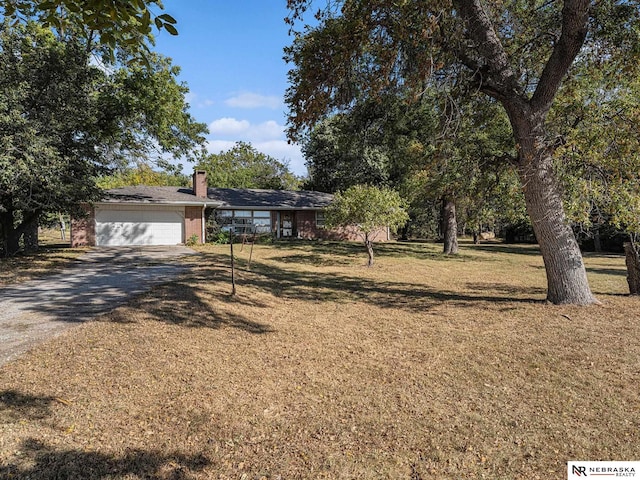 view of front of property with a garage and a front lawn