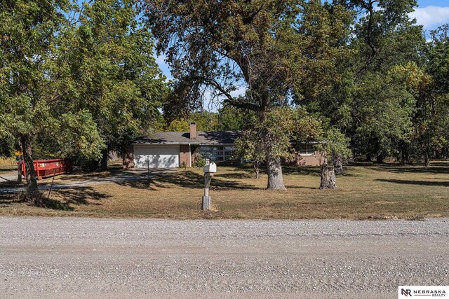 view of front of home with a garage and a front lawn