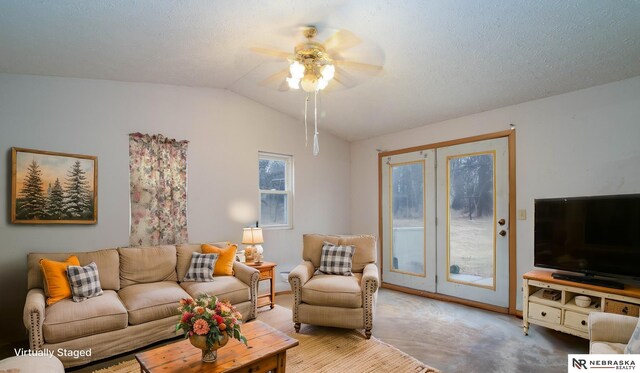 living room featuring carpet floors, a textured ceiling, vaulted ceiling, and ceiling fan