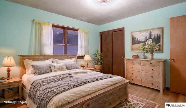 bedroom featuring a closet and light hardwood / wood-style flooring