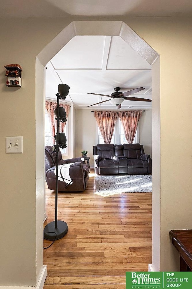 living room with wood-type flooring and ceiling fan