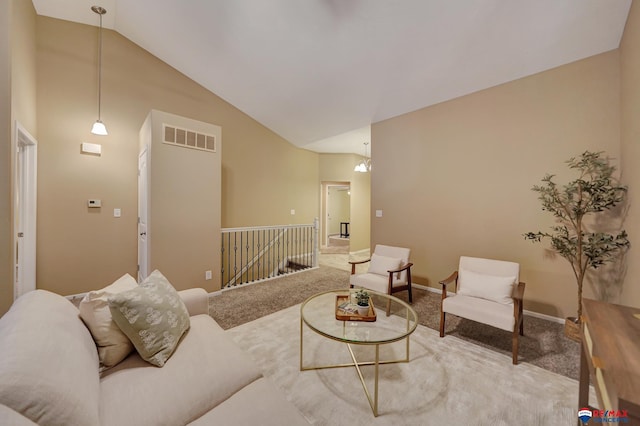 carpeted living room with high vaulted ceiling