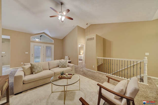 carpeted living room with ceiling fan and lofted ceiling