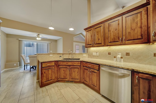 kitchen with decorative light fixtures, sink, decorative backsplash, stainless steel dishwasher, and light stone countertops