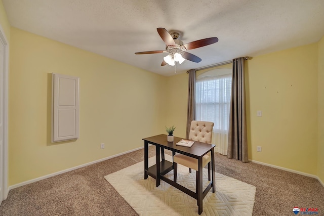 office area with ceiling fan, carpet flooring, and a textured ceiling