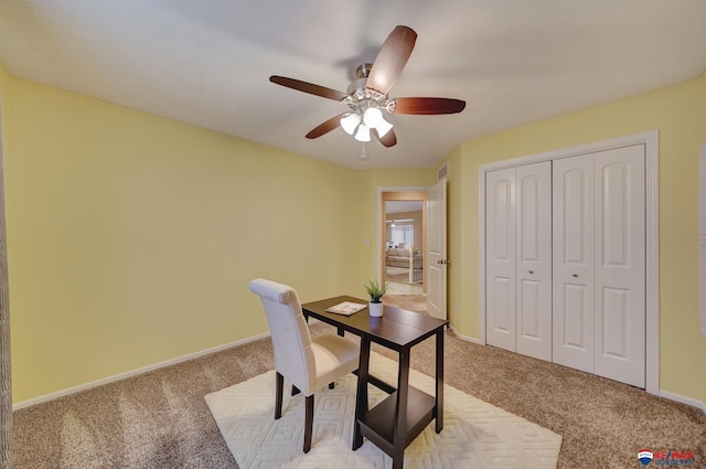 office area featuring ceiling fan and light colored carpet