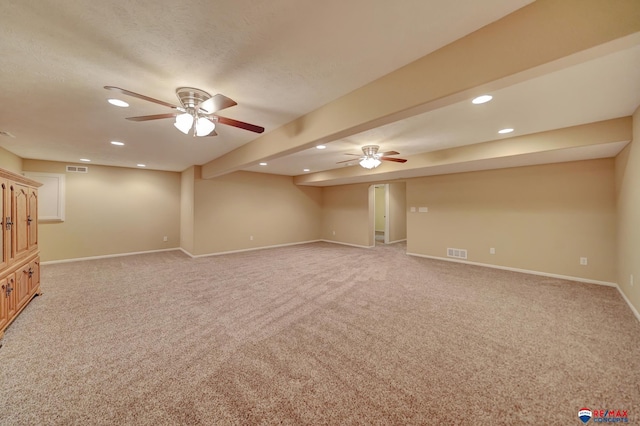 interior space featuring light colored carpet, a textured ceiling, and ceiling fan