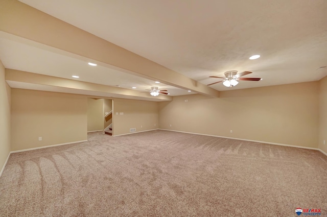 empty room featuring beamed ceiling and carpet floors