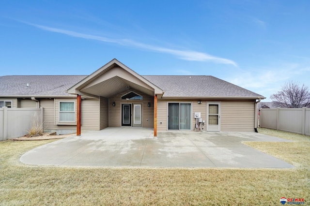 rear view of property featuring a yard and a patio area