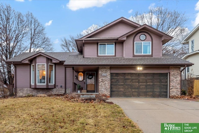 view of front of home with a garage and a front lawn