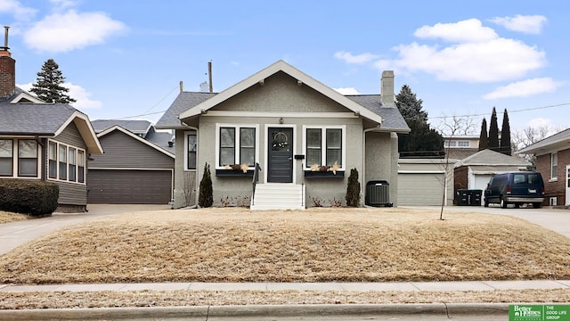 view of front of house with a garage and central air condition unit