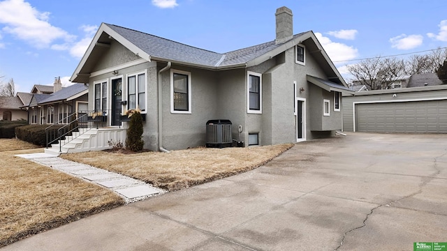 view of side of home with cooling unit and a garage