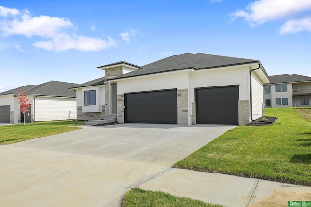 prairie-style house featuring a garage and a front lawn