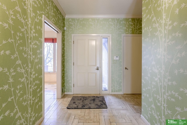 entrance foyer featuring crown molding and light parquet flooring