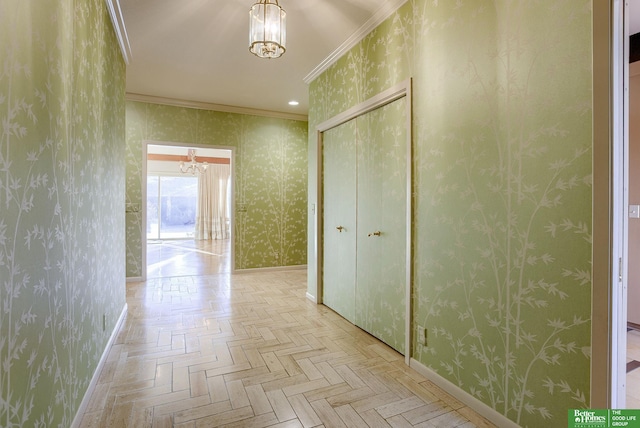 hallway featuring crown molding, a chandelier, and light parquet flooring