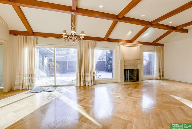 unfurnished living room with an inviting chandelier, light parquet flooring, a premium fireplace, and vaulted ceiling with beams