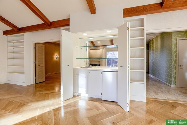 kitchen featuring light parquet floors, sink, refrigerator, and beamed ceiling